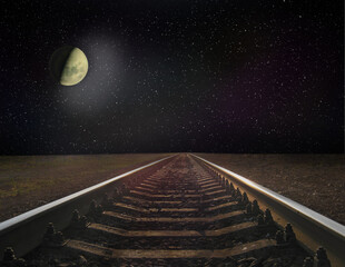 View of rails and the moon at night. Night railway road. Travel concept