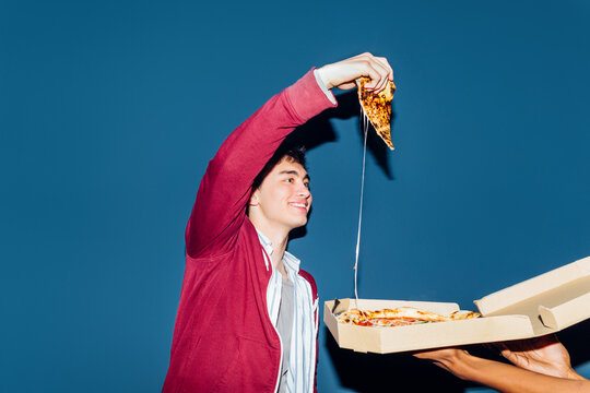 Young man with pizza slice