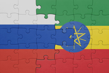 puzzle with the colourful national flag of ethiopia and flag of russia.