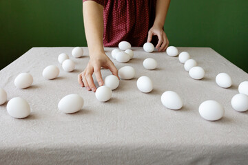 The girl is making a drawing out of eggs 