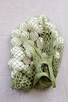 A white egg in a mesh bag 