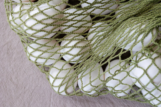 A white egg in a mesh bag 
