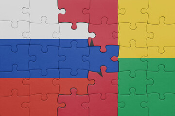 puzzle with the colourful national flag of guinea bissau and flag of russia.