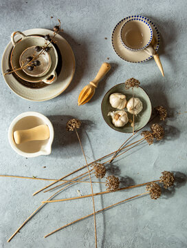 Still life with dried berries and garlic flowers with kitchenware