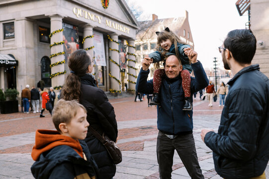 family at quincy market in boston together during holiday season