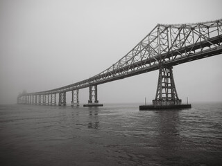 Vast bridge over water with a building in the background