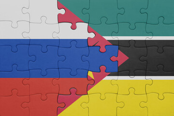 puzzle with the colourful national flag of mozambique and flag of russia.