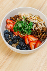 Close-up of cereal, berries, and greens mixed in a delicious dish