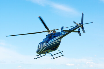 Bell helicopter in flight against the sky
