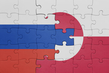 puzzle with the colourful national flag of greenland and flag of russia.