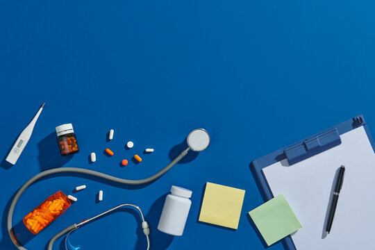 top view of different medicines and electric thermometer