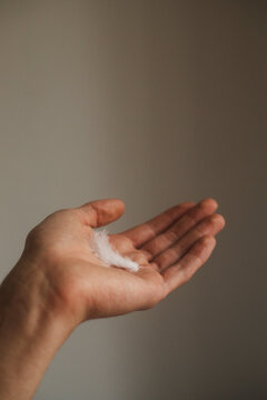 White feather on a man's hand