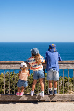 Sibling looking out the ocean on a beatiful day