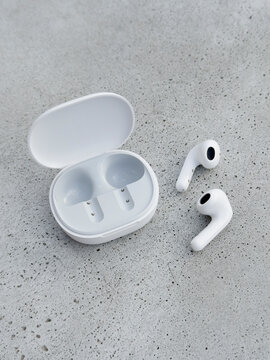 White wireless ear buds and a case