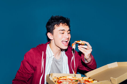 Young man eating pizza 