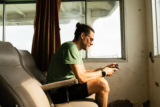 Young man sitting on an empty ferry boat