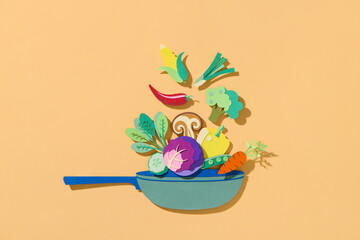Creative collage of fresh vegetables fly into a pan