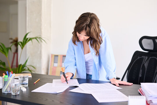 Diligent Businesswoman Editing Documents at Work