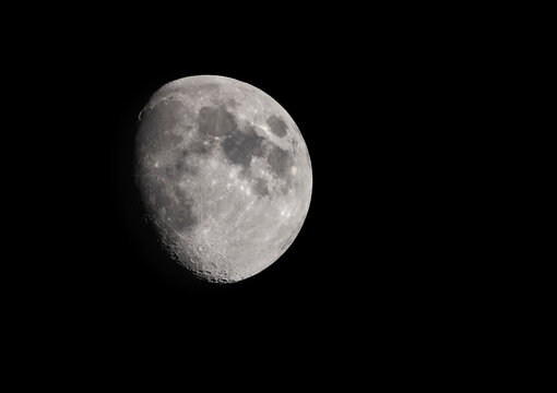 A three quarter moon in a clear sky