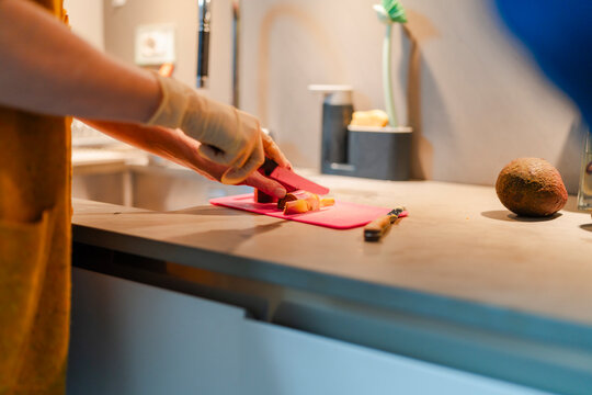 Senior Female Preparing Food with Bandaged Hand