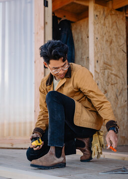 man building on wood deck