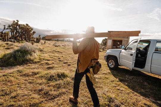 woodworker carrying wood to project