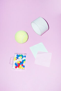 View of desk with tennisball, notes, tape roll and paper pins 