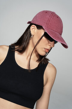 Woman wearing a pink/red baseball cap