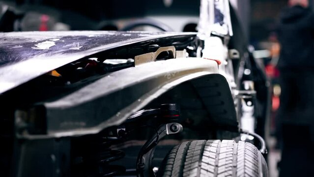 close-up at a service station of the front of a car after an accident without bumper