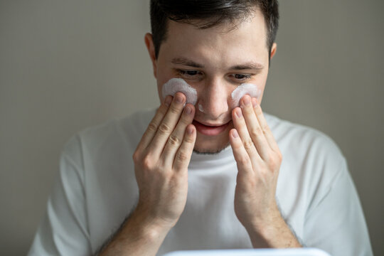 Man applying cream on his face 