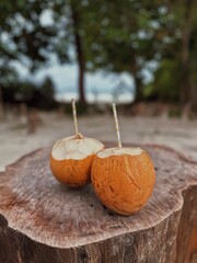 Two coconuts with a straw