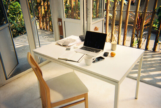 White table with netbook on veranda