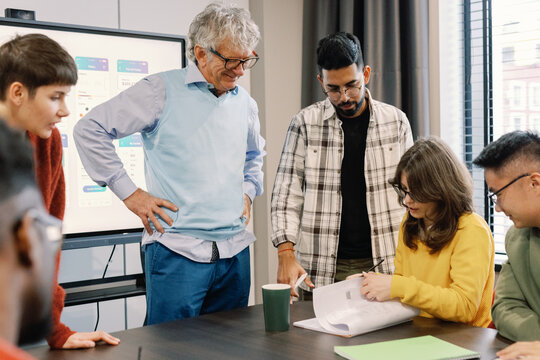 Team checking project draft common work modern office
