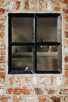 Vintage window in rustic brick wall