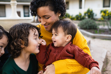 Joyful brothers play while mother looks on