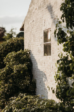 Sunlit rustic building with a single window