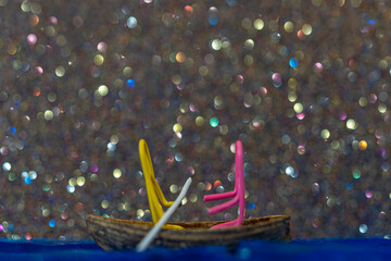 Toy boat on a glittery background