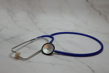 Stethoscope on marble surface for heart rhythm check