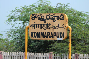 Information board with the name of Kommarapudi railway station written in Hindi, Telugu and English.