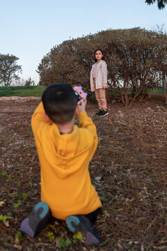Boy In Yellow Captures Sister's Portrait.