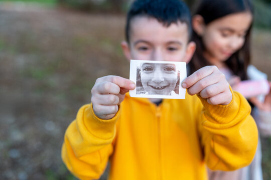 Joyful Child With Instant Print Portrait.
