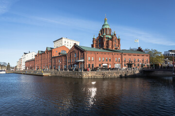 large building with tower next to water in the city area