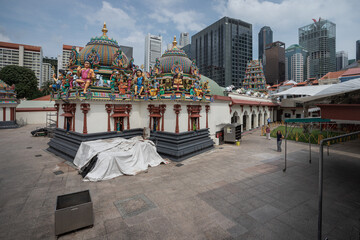 the outside of a hindu temple with a white covering over it