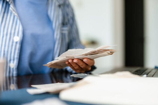 A woman with receipts is sitting at a table