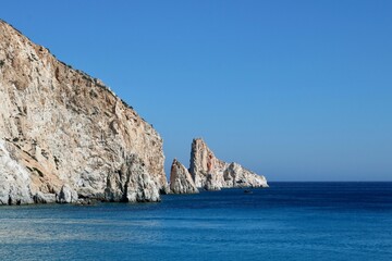 View of the ocean through a rock archway.