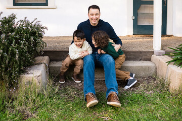 Young brothers having fun together with their dad