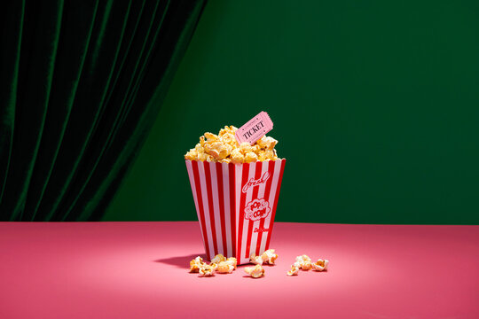 Buckets with delicious popcorn on red-green background
