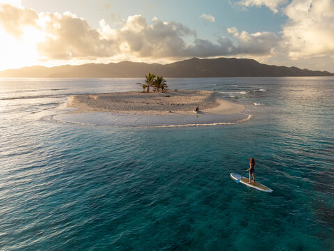 Woman at Remote Caribbean Island with Stand Up Paddle Boards