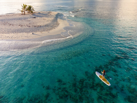 Woman at Idyllic Caribbean Island on SUP Board