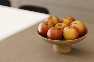Basket with fresh fruits on table in kitchen